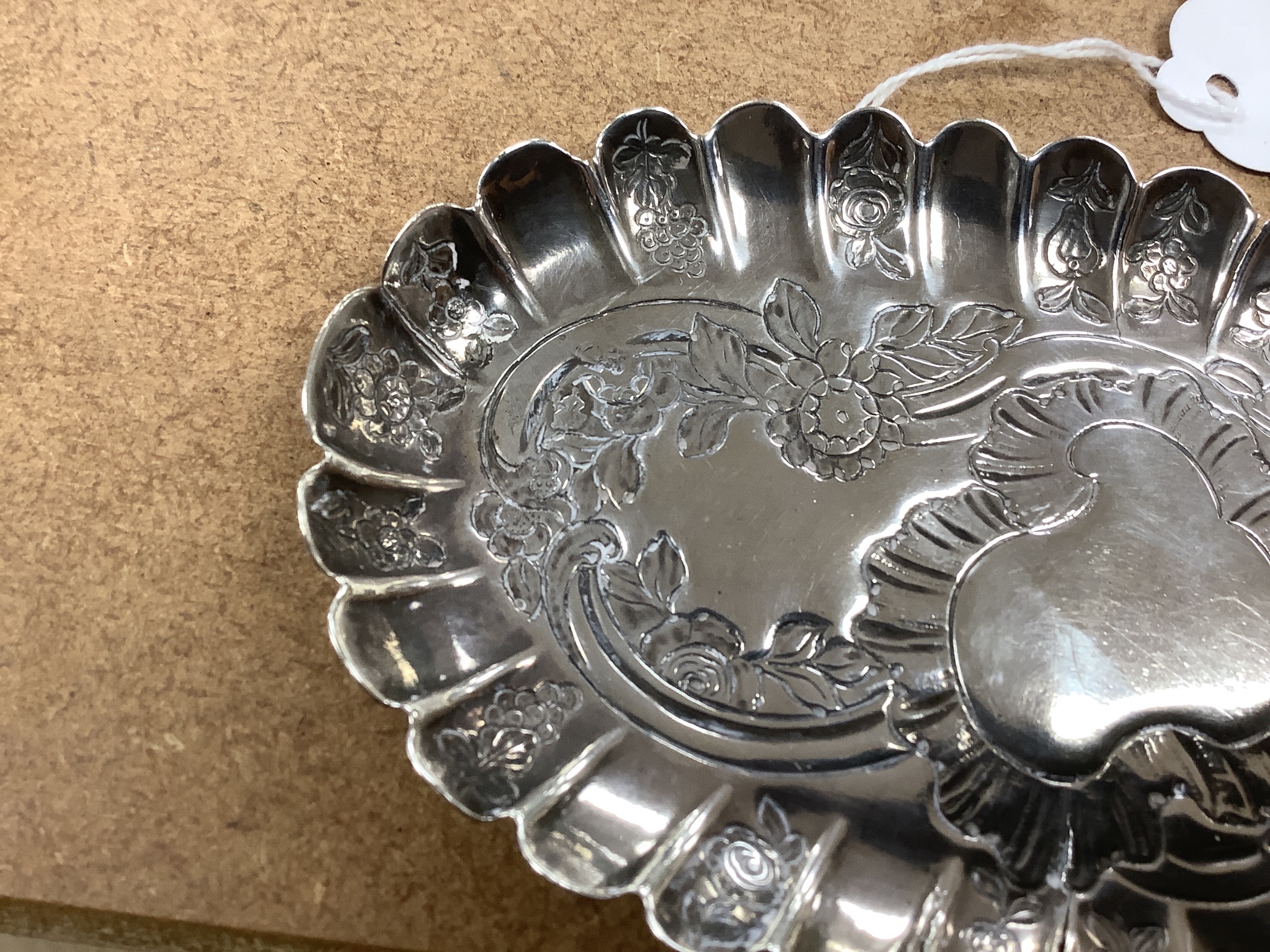 A mid 18th century Irish embossed silver oval pin tray, with engraved date and initials, maker ID?, Dublin, circa 1750, 16.4cm, 74 grams (a.f.)